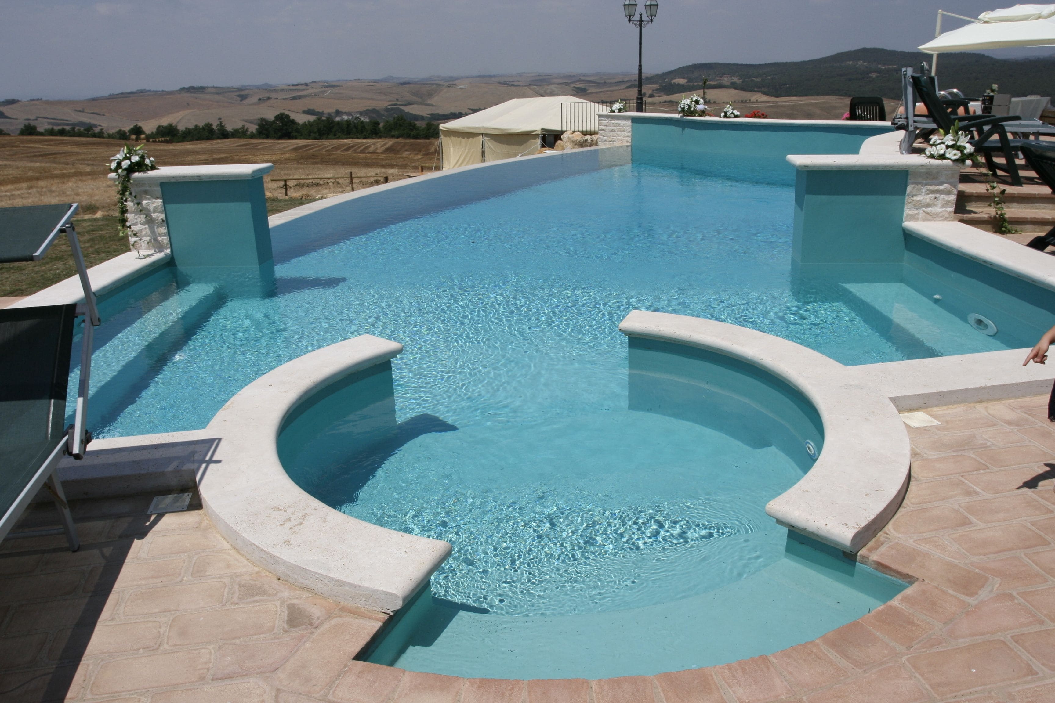 A swimming pool with a view of the countryside.