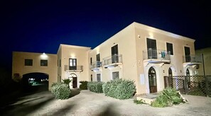 A two-story building with a symmetrical facade, multiple balconies, and a gated entrance. - B&B Tramonti d'aMare (Marsala)
