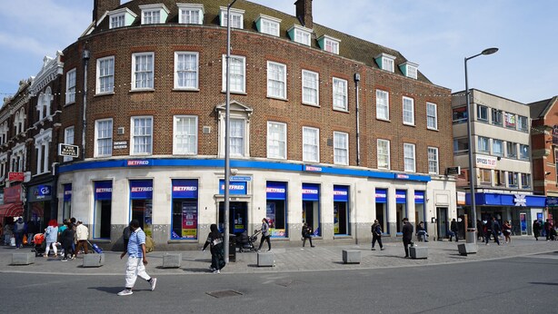 Un edificio en esquina con varias tiendas Betfred en la planta baja.