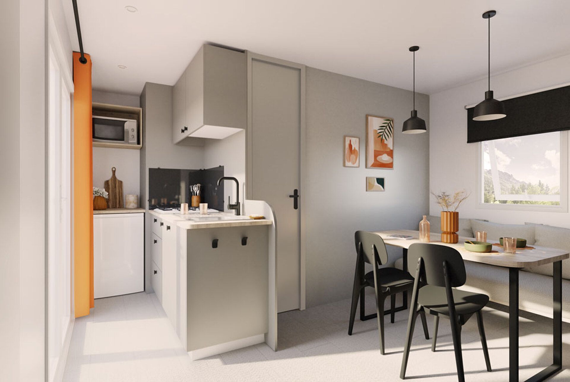 Une cuisine moderne équipée d’un four à micro-ondes, d’un évier et d’un coin repas avec des chaises et une table.
