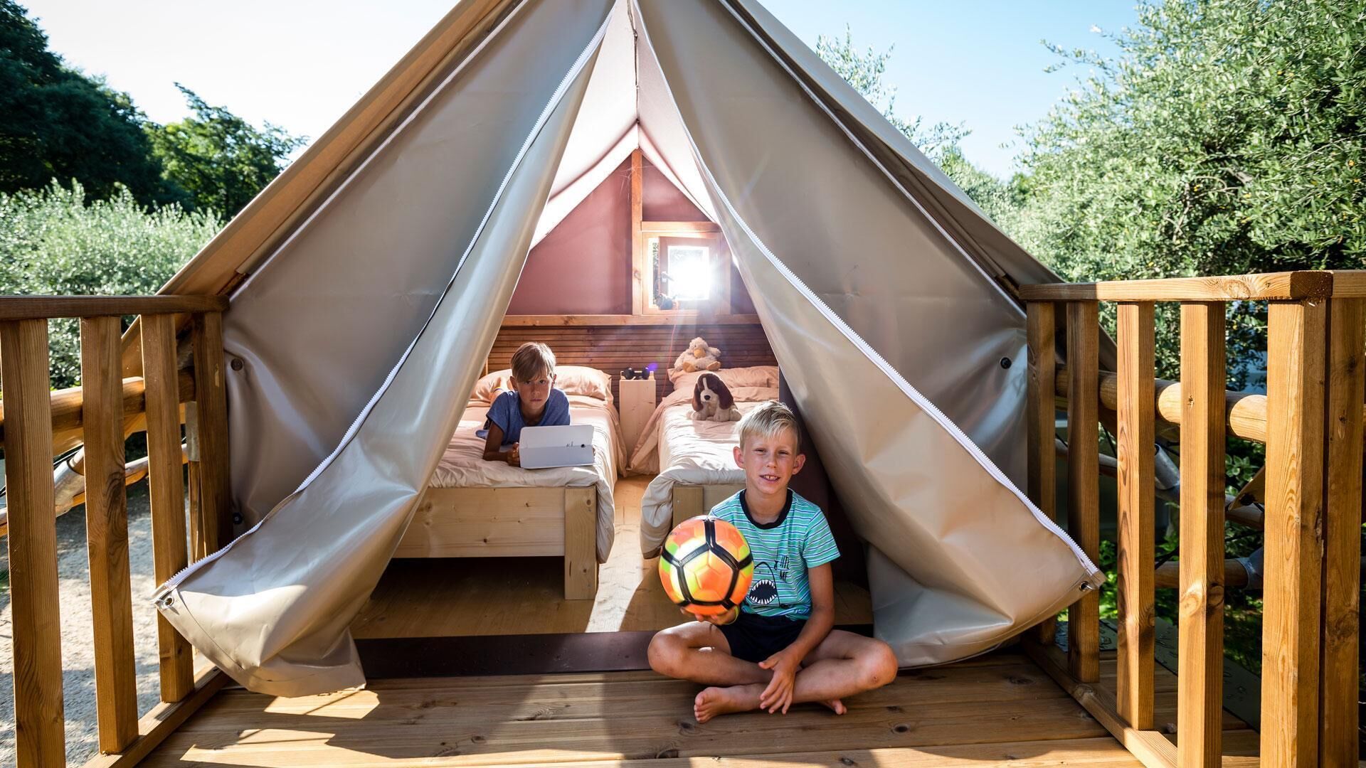 A wooden deck with a tent structure.