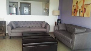 A living room with two sofas, a coffee table, and a lamp.
