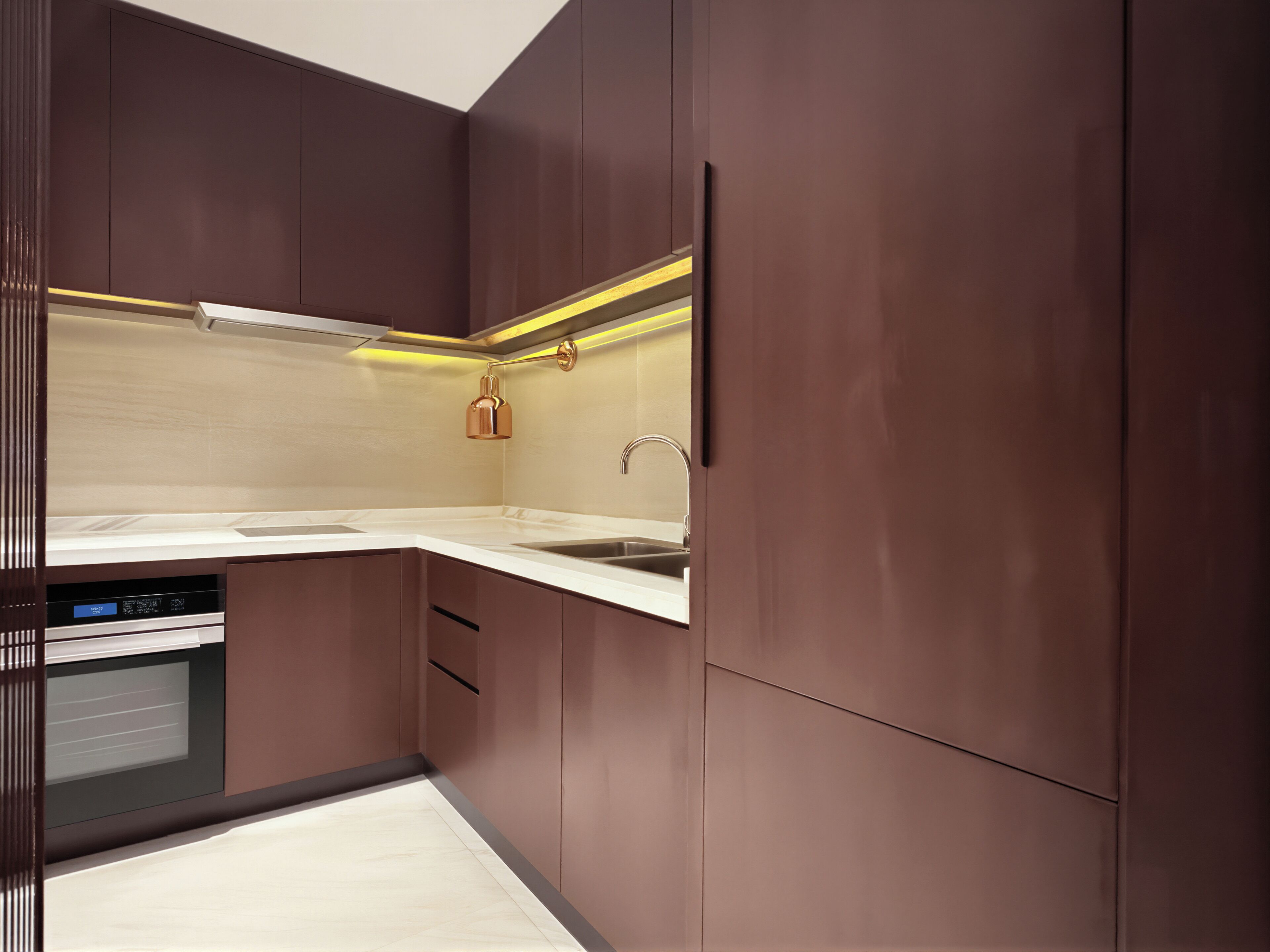 A modern kitchen with dark cabinetry, a stainless steel sink, and a built-in dishwasher.