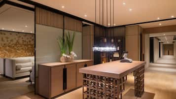 A modern kitchen with a wooden island, built-in appliances, and a decorative wall.