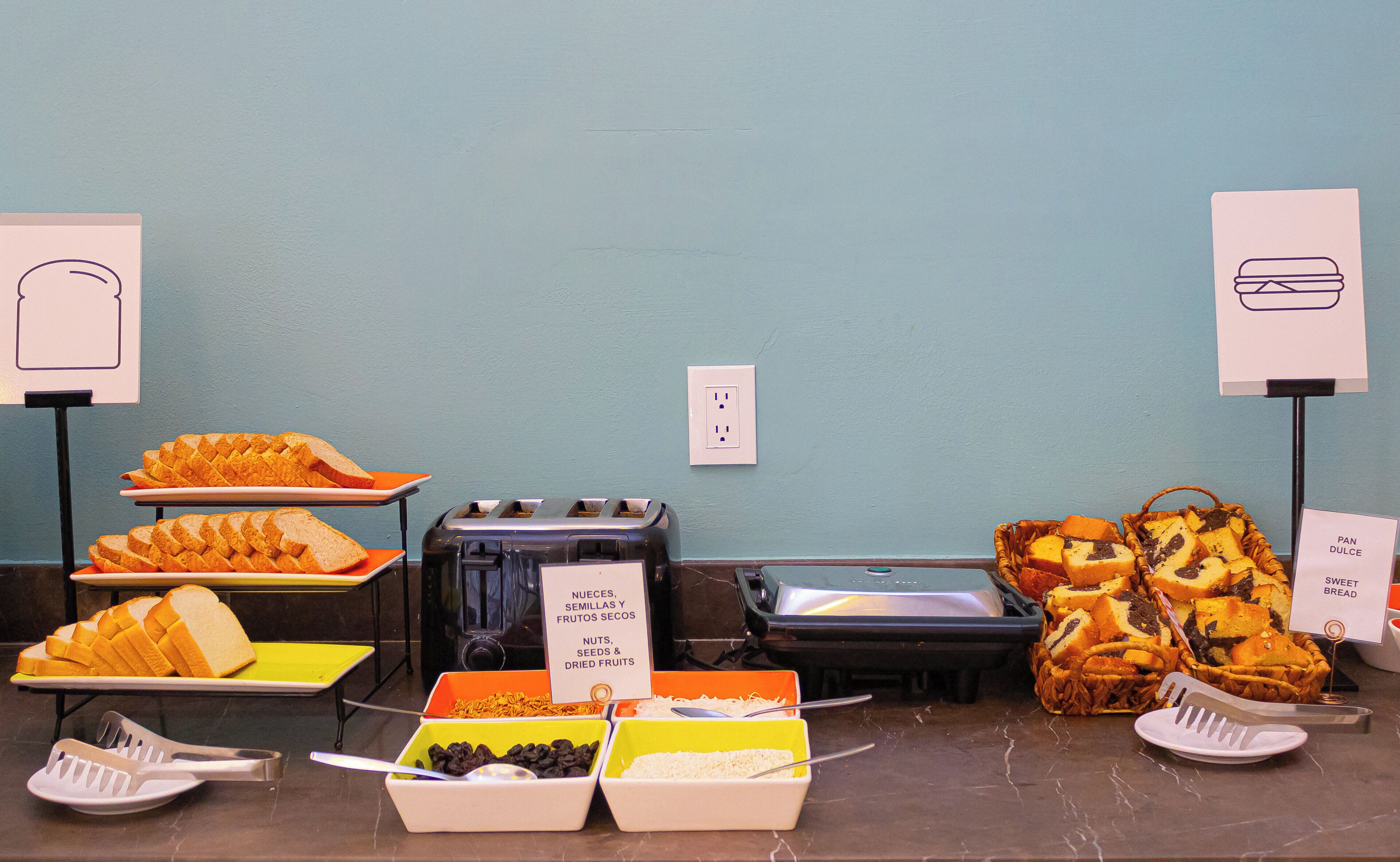 A buffet setup with various food items and serving utensils.