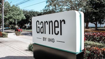 A sign with the name 'Garnier' and 'BY IHG' indicating a hotel or property associated with the IHG brand.