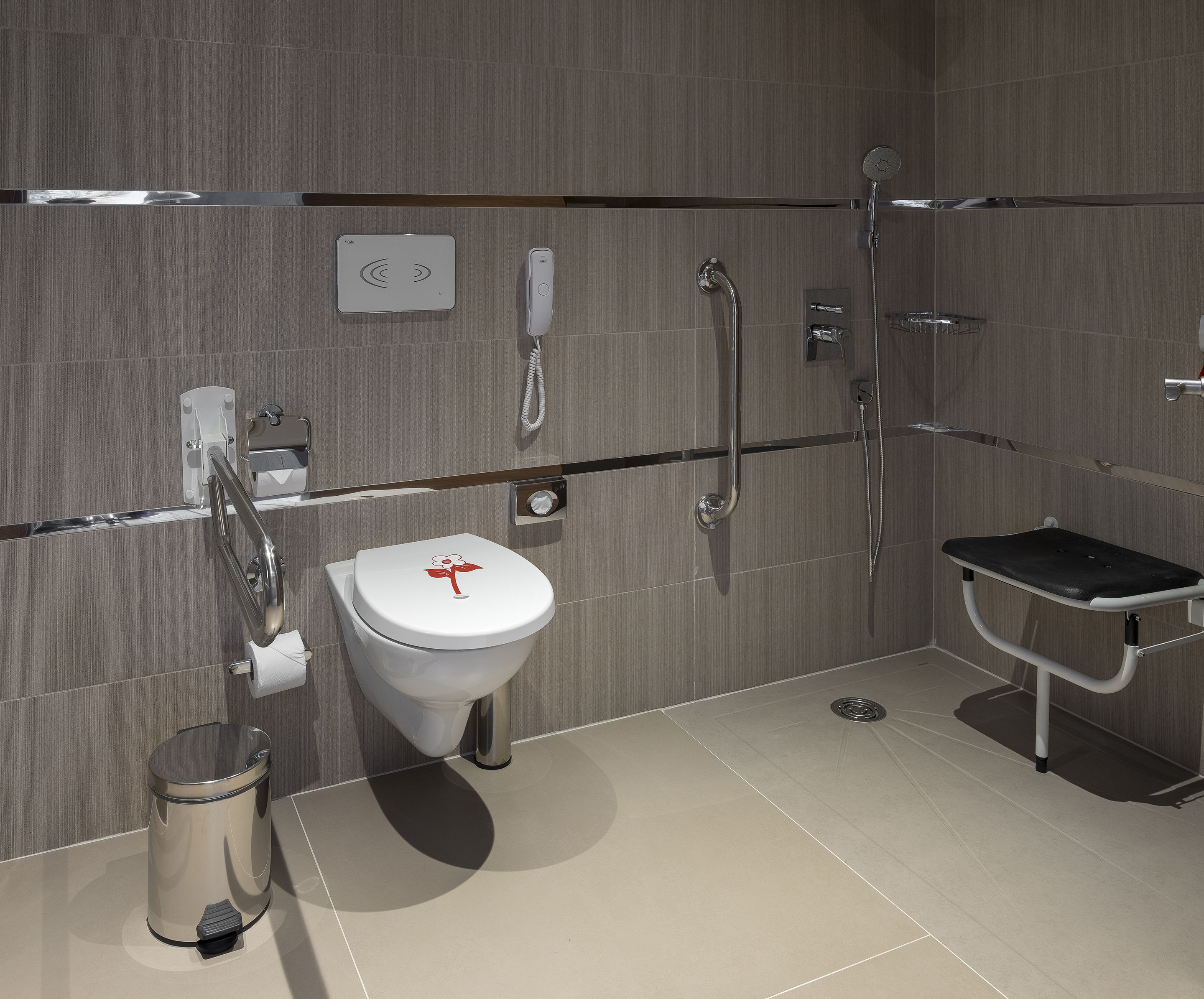 A modern bathroom with a toilet, bidet, and shower.