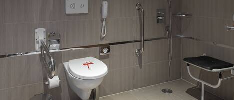 A modern bathroom with a toilet, bidet, and shower.