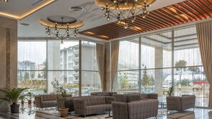 A spacious lobby with large windows, a modern chandelier, and multiple seating areas. - Ramada Plaza by Wyndham Rize (Rize)