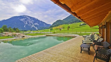 Outdoor pool, a natural pool, pool loungers