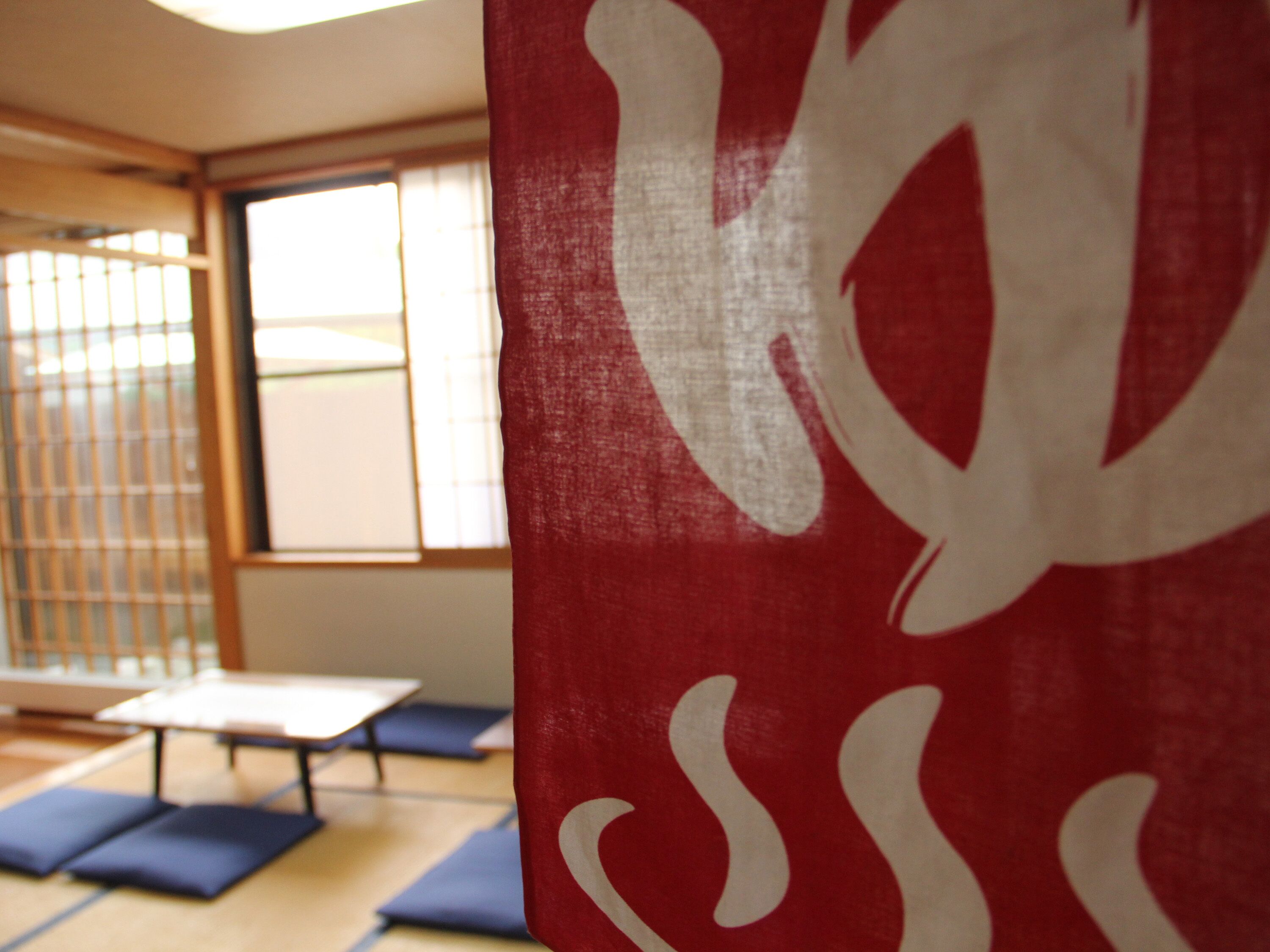 A tatami mat room with a sliding door and a table.