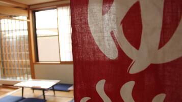 A tatami mat room with a sliding door and a table.