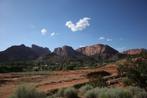 Paisaje desértico con montañas al fondo y vegetación escasa en primer plano.