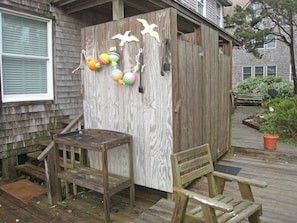 Relax in an outdoor space with a bench and table, perfect for dining or unwinding.
