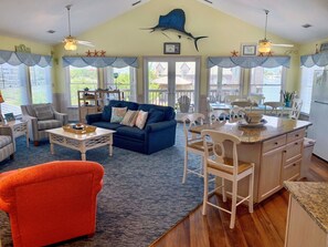 Relax in a cozy living space with a comfortable sofa, dining area, and maritime-themed decor.