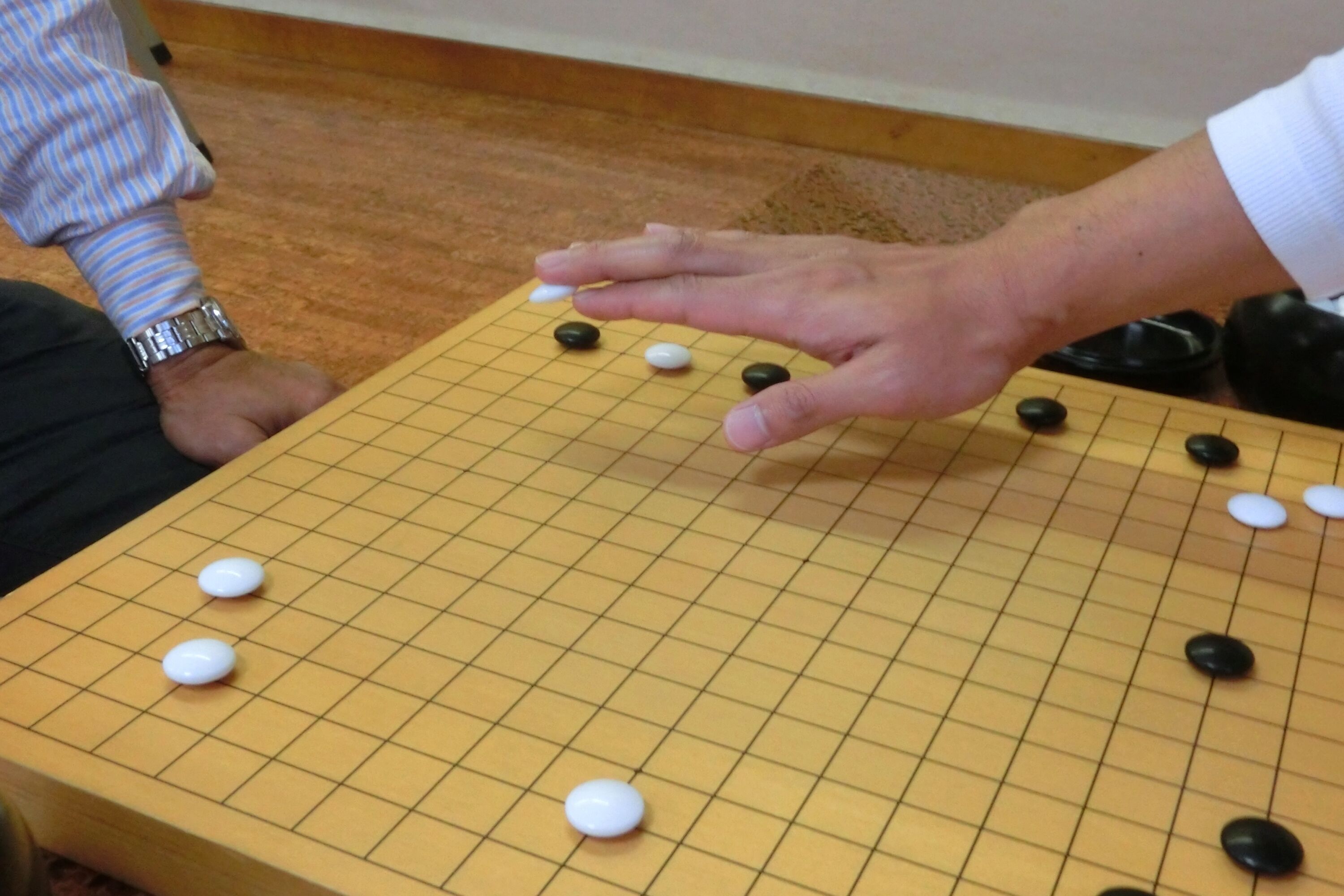 A Go board with pieces in play, indicating a game in progress.