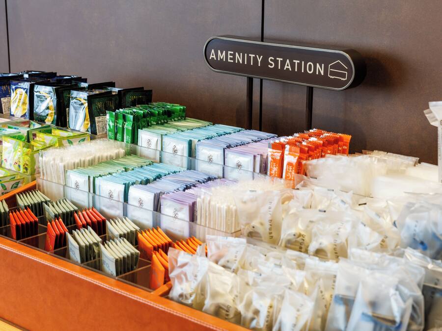 A display of toiletries in a hotel setting with a sign indicating the 'Amenity Station.'