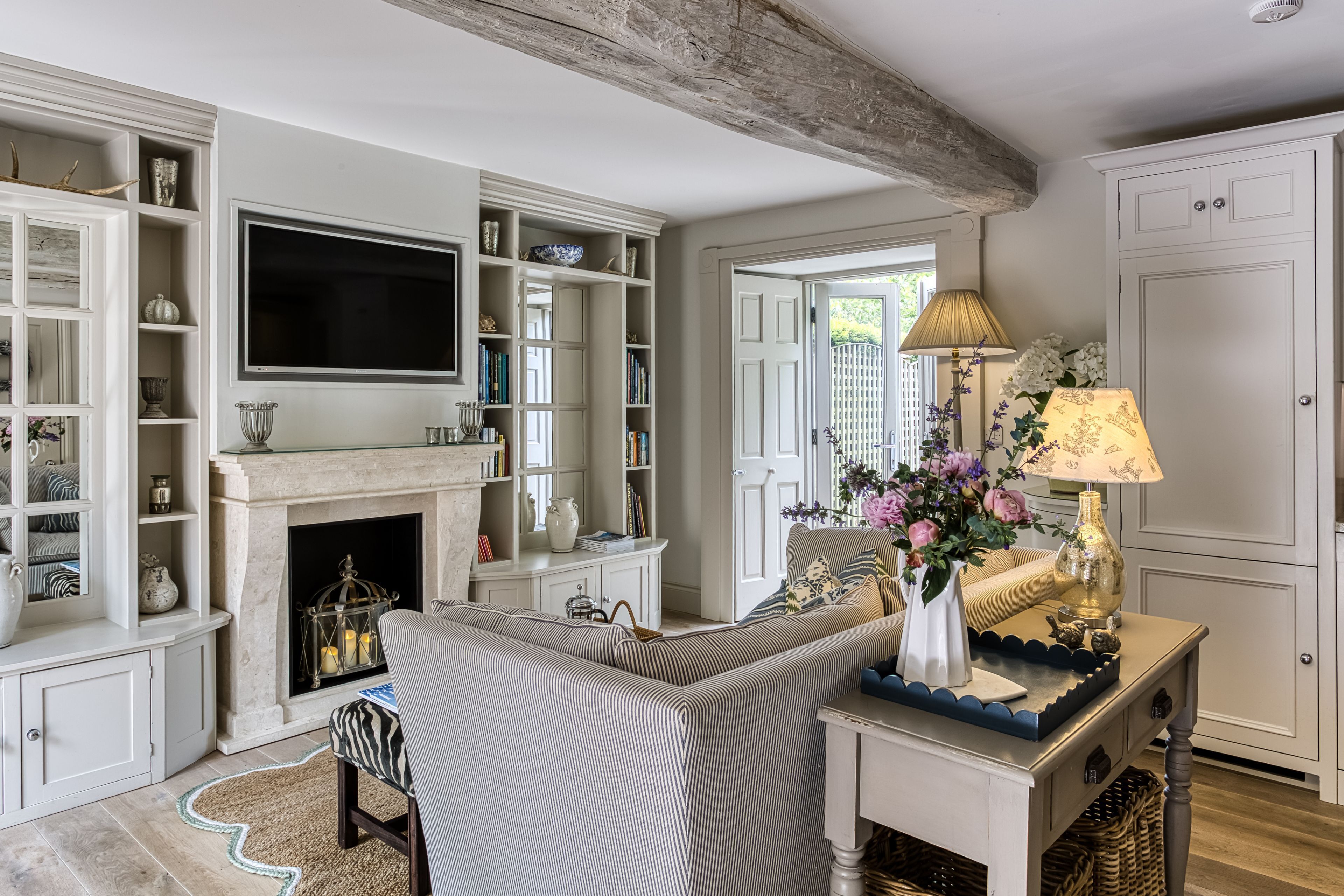 A living room with a fireplace, a television, and a sofa.