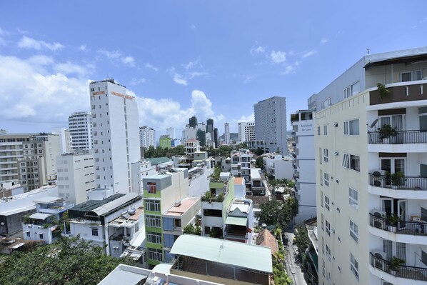 A high-rise building with multiple balconies and a sign indicating it is for lease. - Alibaba Hotel (Nha Trang)