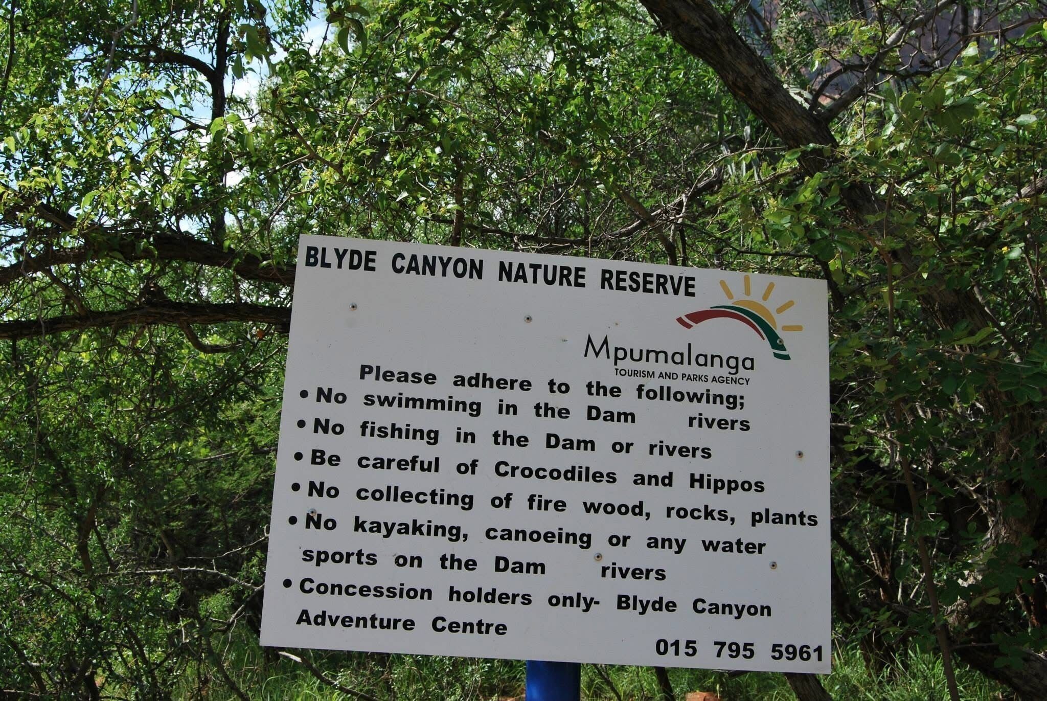A sign for Blyde Canyon Nature Reserve with a list of rules and a contact number.