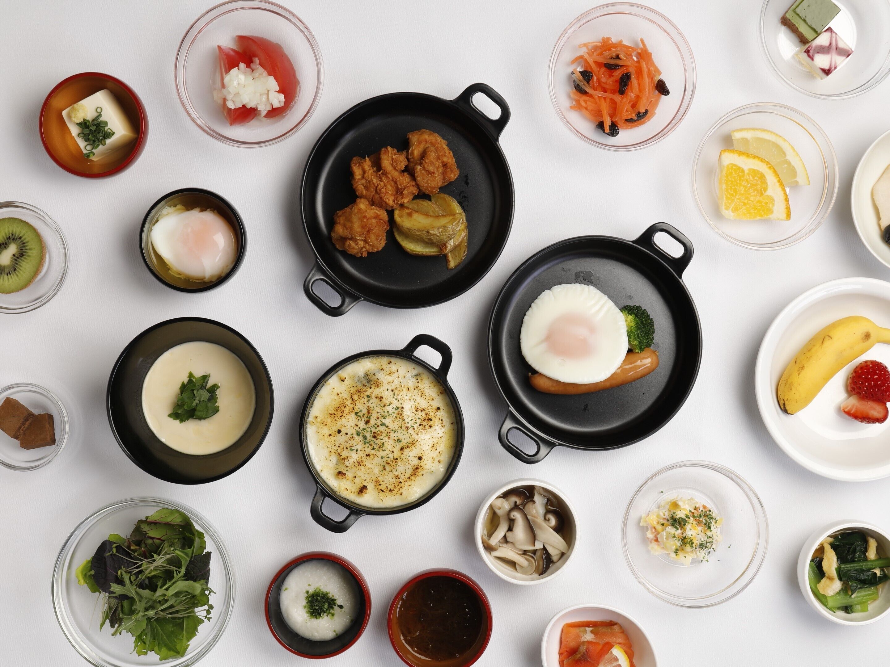 A variety of dishes and food items arranged on a table.