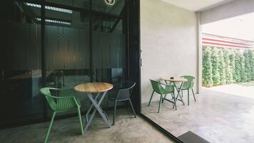 A modern interior with a glass door leading to a patio area.