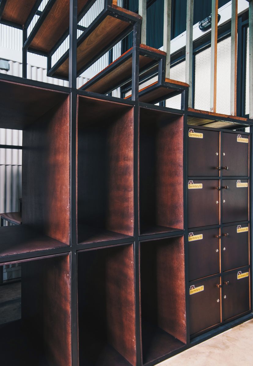 A set of metal shelving units with multiple compartments, some labeled as "Dormitory 01" and "Dormitory 02".