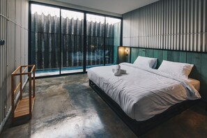 A bedroom with a large bed, a wooden ladder, and a view through a sliding door. - The Tree Sleep and Space (Trang)