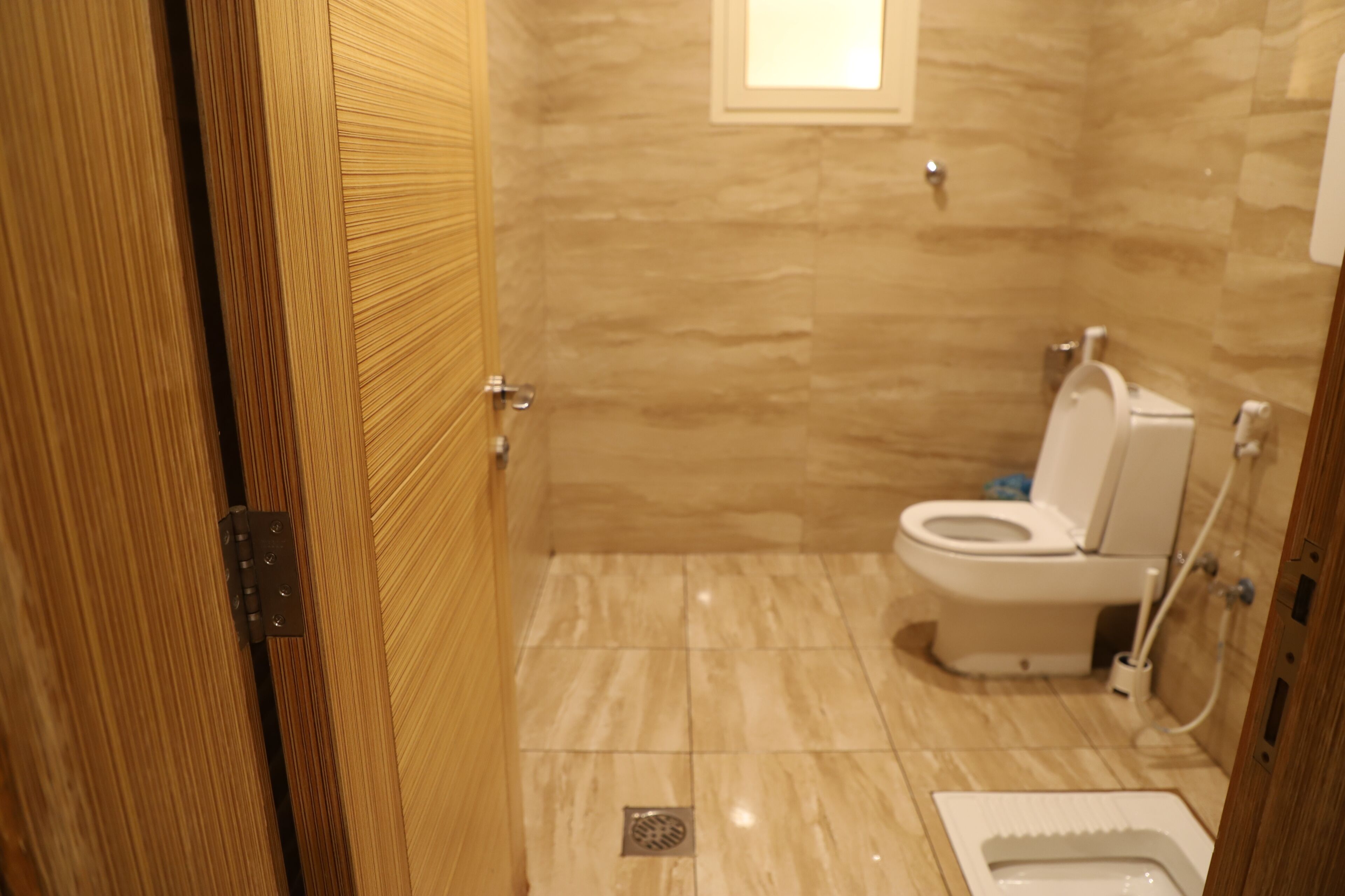 A bathroom with a toilet, bidet, and a shower area.