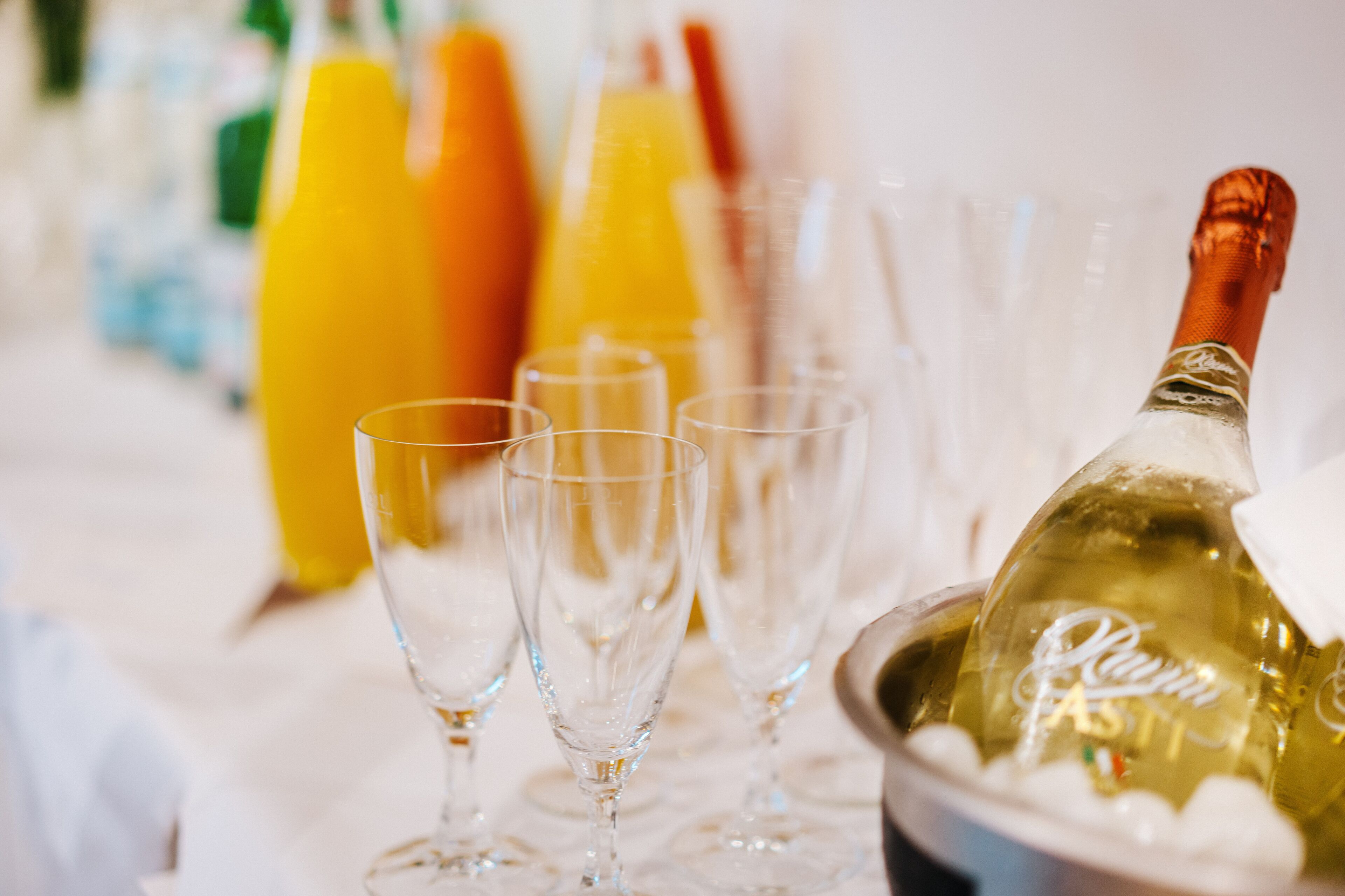 A table with champagne bottles and glasses.