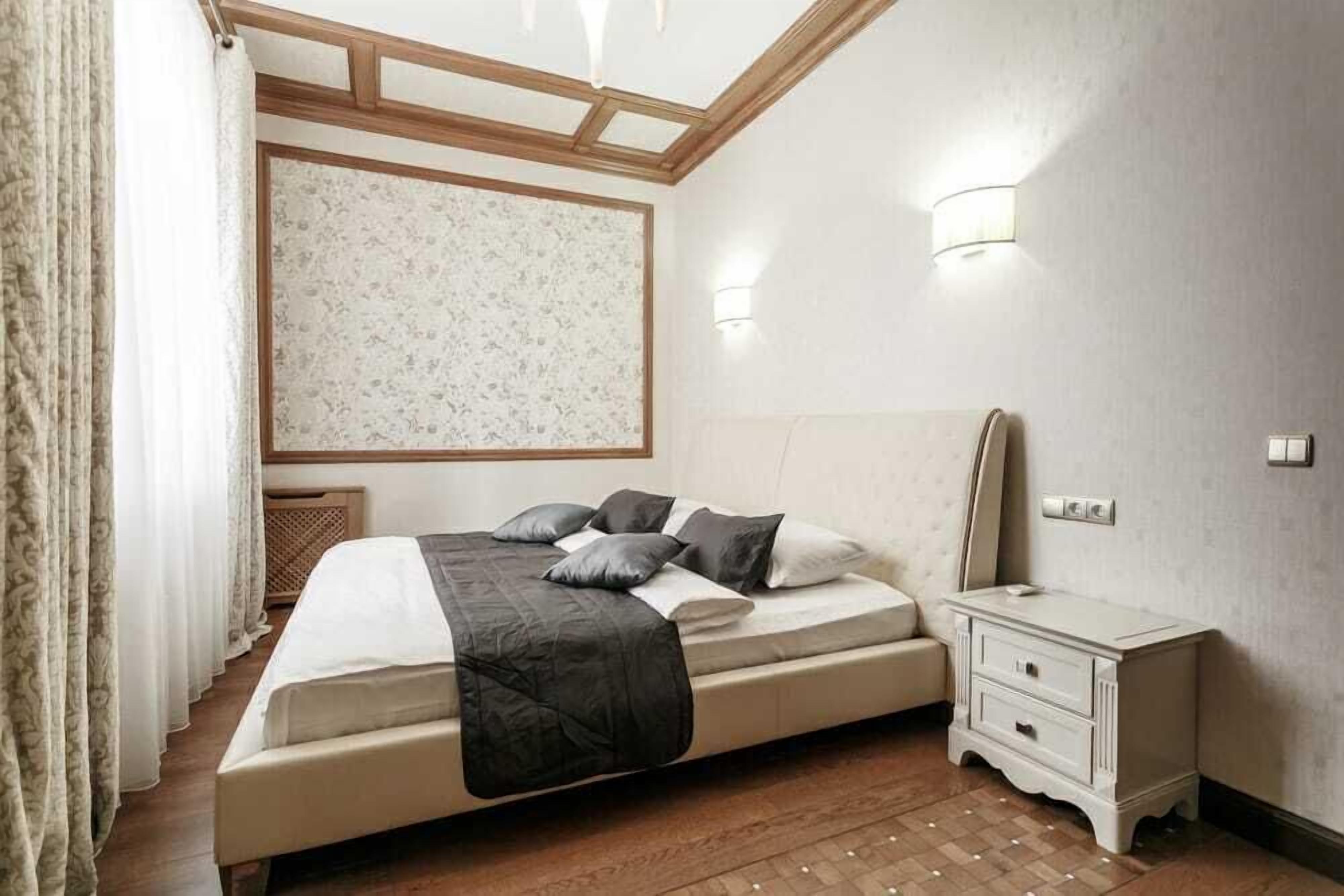 A bedroom with a bed, bedside table, and a headboard.