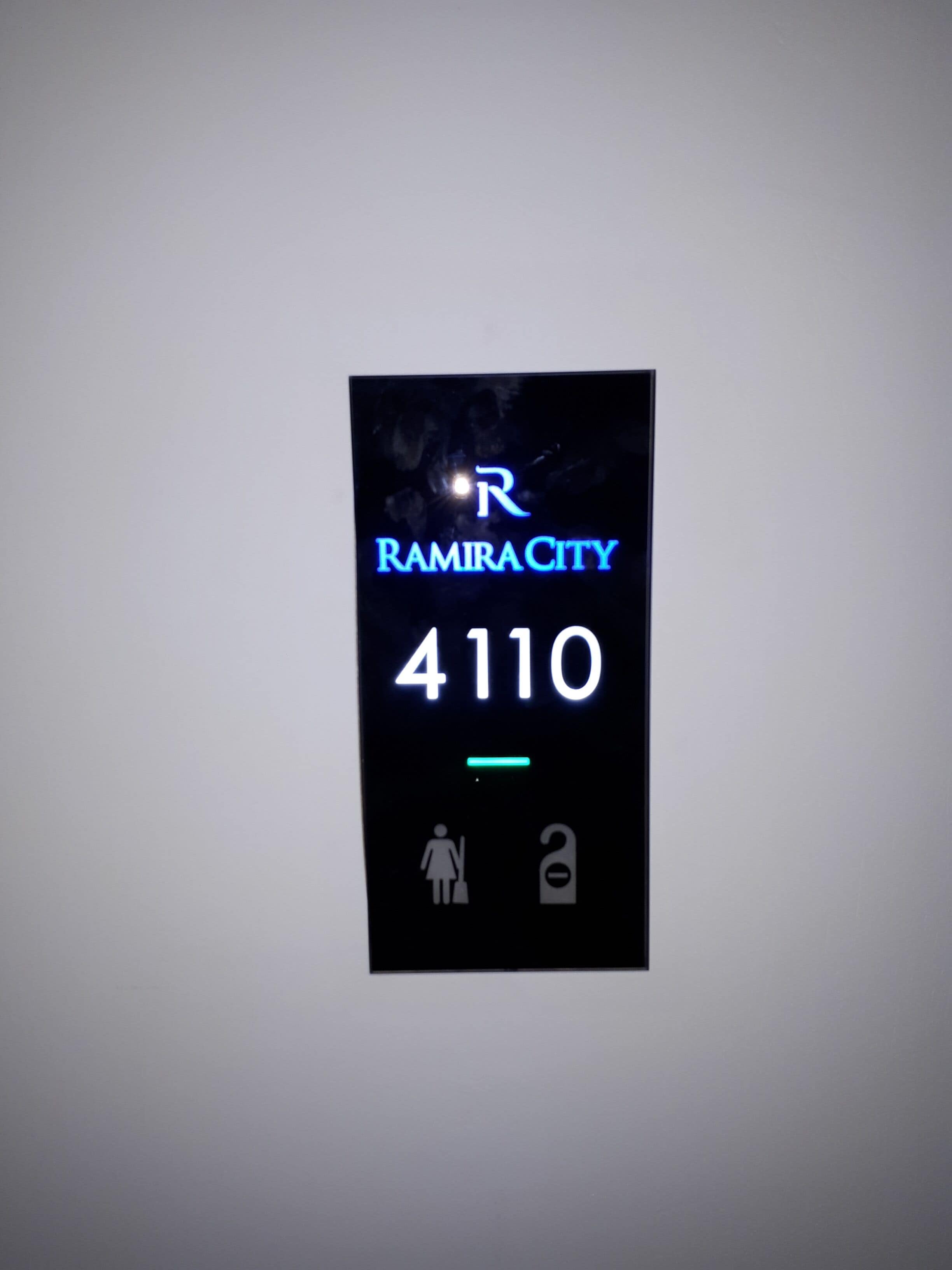 A digital display with "RAMIRACITY 4110" and icons for a restroom and a security door.