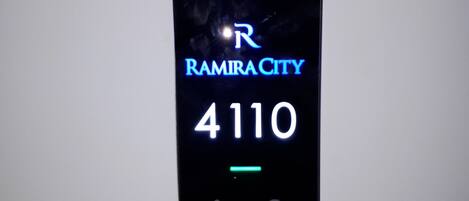 A digital display with "RAMIRACITY 4110" and icons for a restroom and a security door.