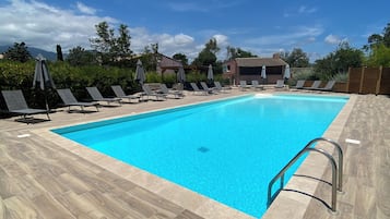 Outdoor pool, open 8:00 AM to 8:00 PM, pool loungers