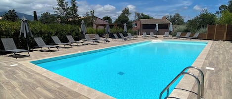 Outdoor pool, open 8:00 AM to 8:00 PM, pool loungers