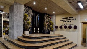 A staircase with a modern design, leading to a door with a decorative panel.