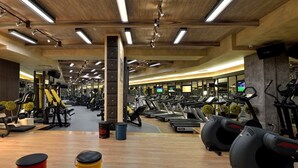 A gym with various exercise machines, including treadmills and weightlifting equipment.