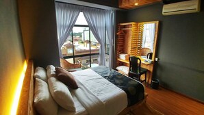 A bedroom with a bed, a desk, and a window with curtains. - Urban Industrial City View (Malacca City)
