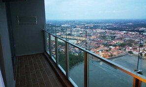 Enjoy breathtaking views of the city from this high-rise's expansive balcony.