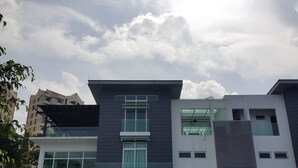 A modern multi-story building with large windows and a flat roof. - La Maison 100 (Kuala Lumpur)