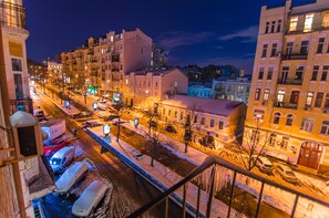 A nighttime cityscape with snow-covered streets and illuminated buildings. - Rent Kiev Lva Tolshtoho Square (Kyiv)