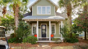 A two-story house with a front porch, a black front door, and a number '2452' on the wall.