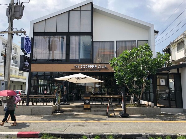 A modern building with a sign for 'The Coffee Club' cafe, bar, and restaurant.