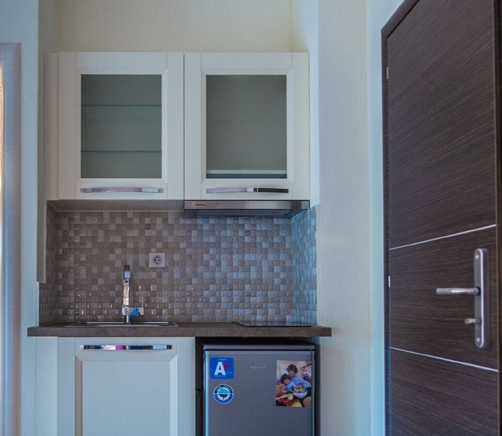 Fridge, electric kettle, cookware/dishes/utensils, dining tables