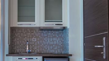 Fridge, electric kettle, cookware/dishes/utensils, dining tables