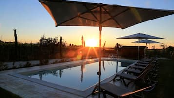 Seasonal outdoor pool, open 9:00 AM to 7:00 PM, pool umbrellas