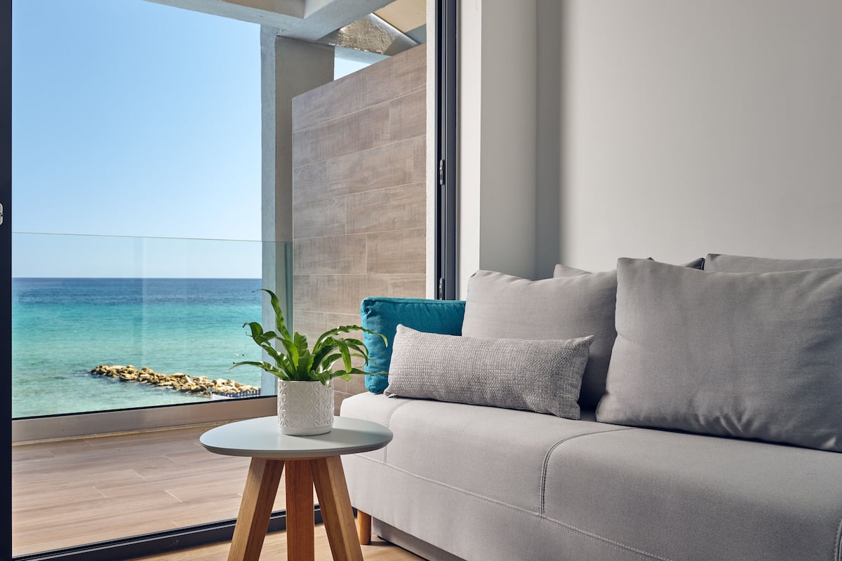 seaside suite with panoramic sea view | living area | flat-screen tv