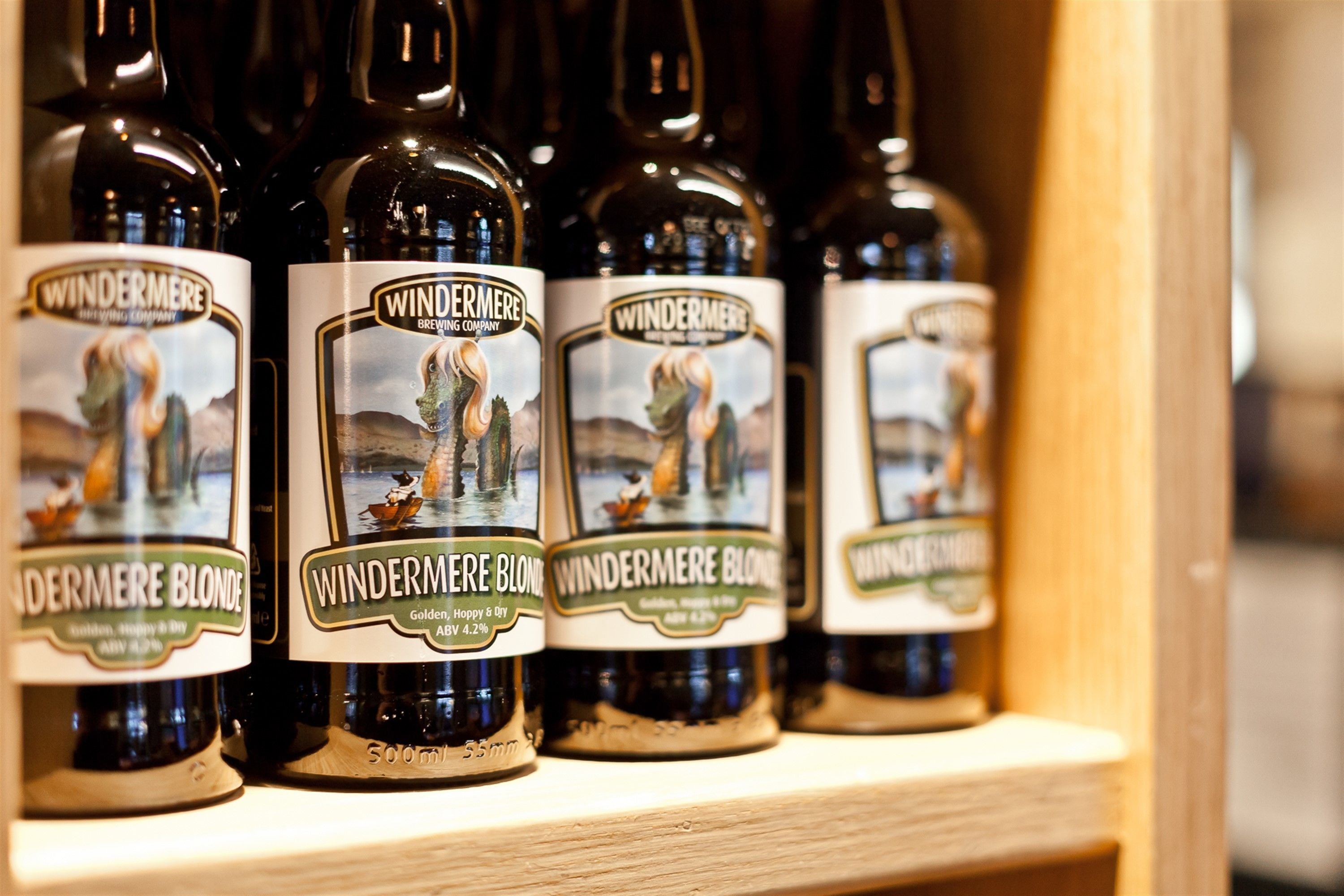 Bottles of Windermere Blonde beer on a shelf.