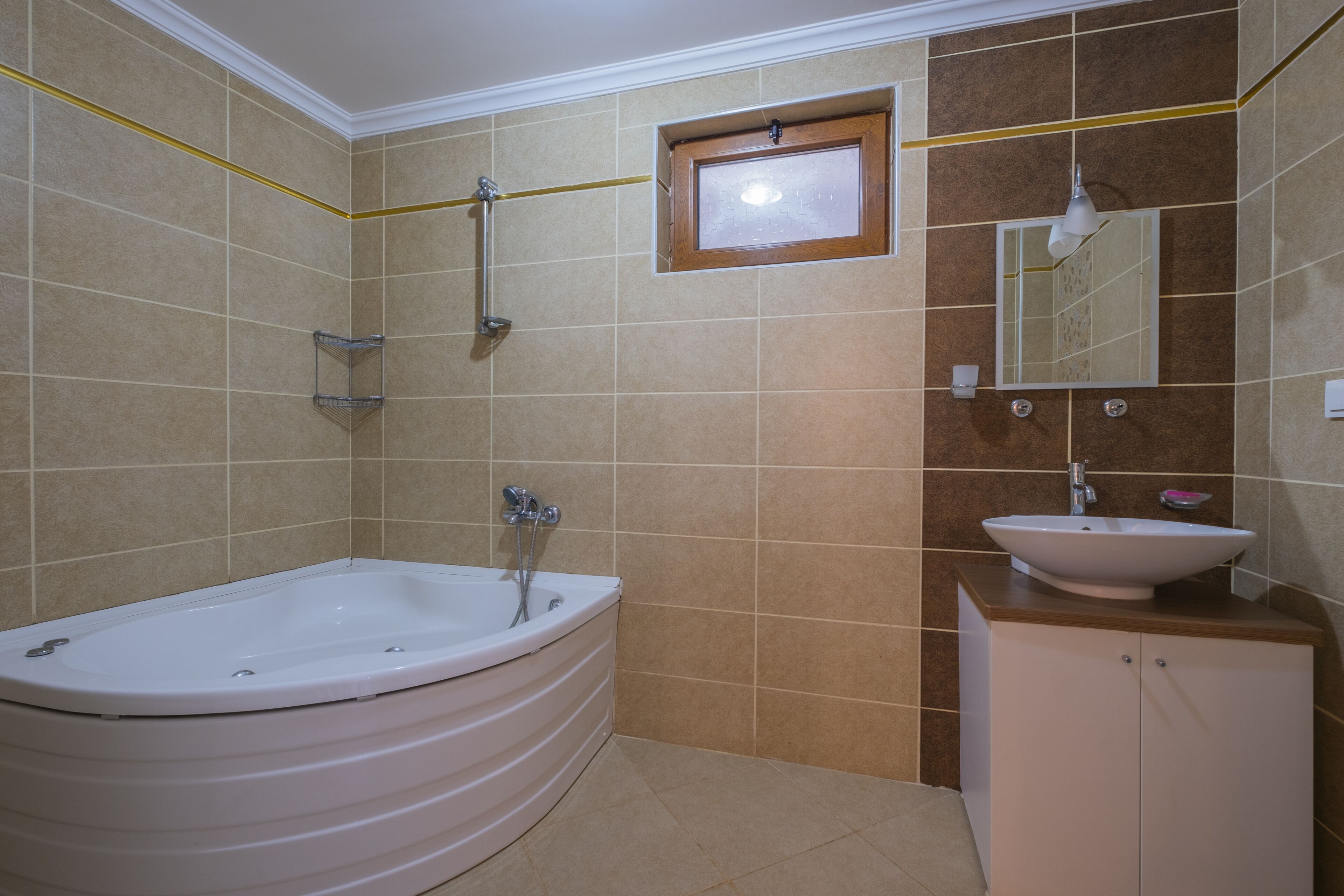 A bathroom with a freestanding bathtub, a sink, and a mirror.