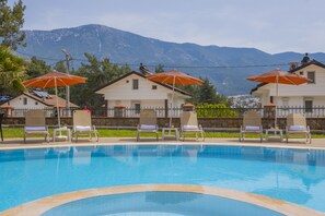 Seasonal outdoor pool, pool umbrellas, pool loungers